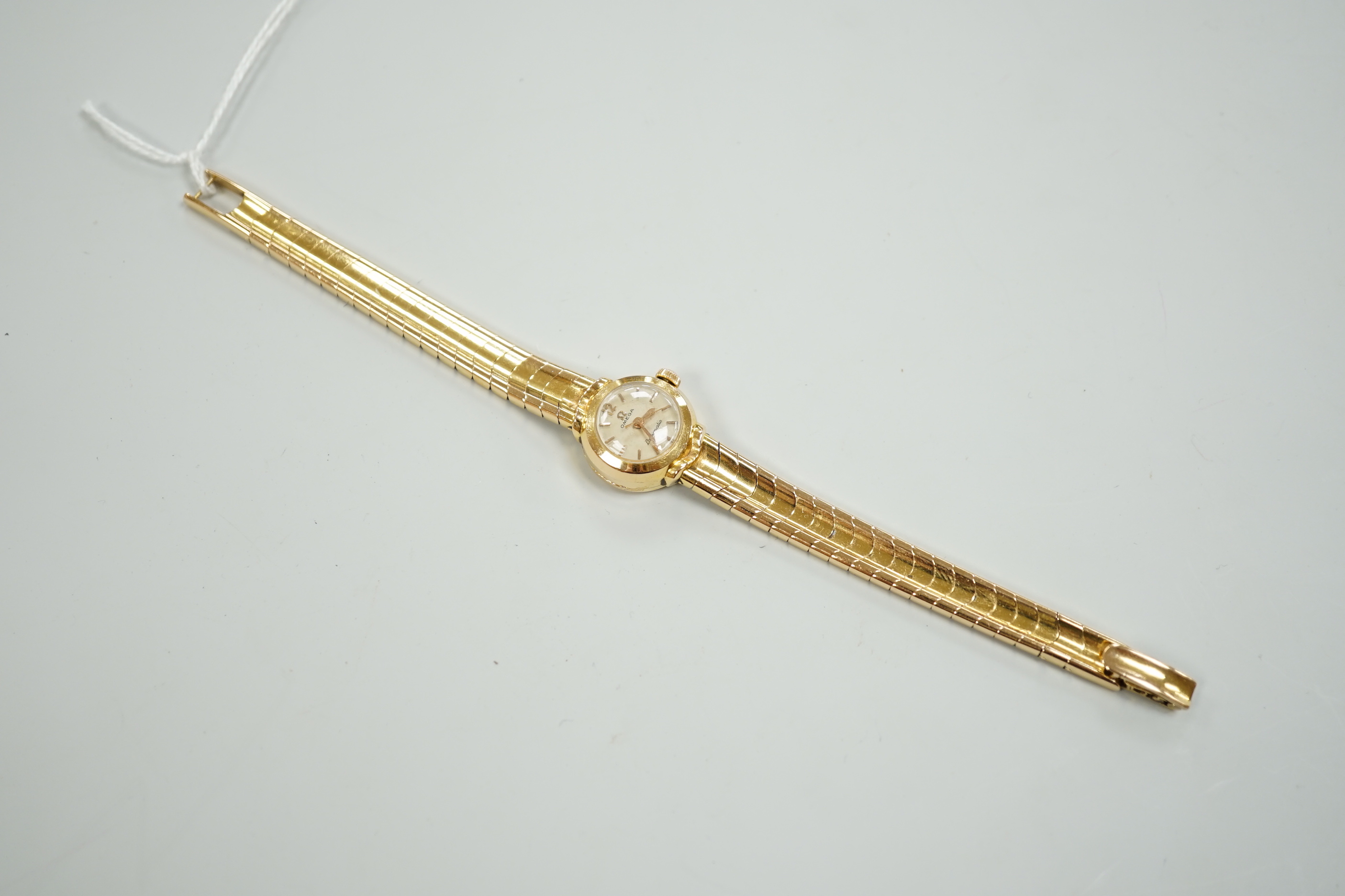 A lady's yellow metal, stamped 750, Omega Ladymatic wrist watch, on a 750 bracelet, length 17.cm, gross weight 38.9 grams.